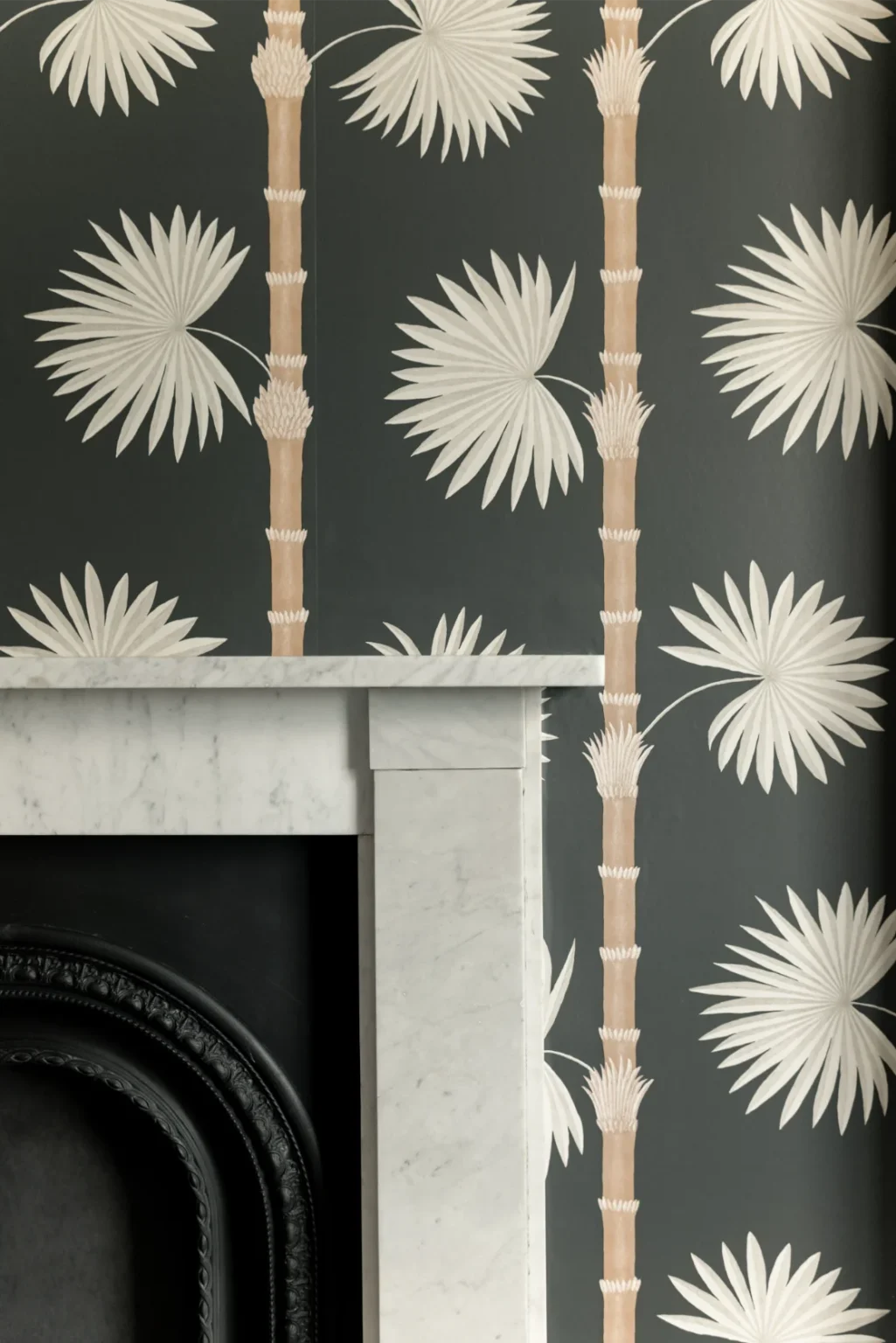 Tropical wallpaper beside marble fireplace detail
