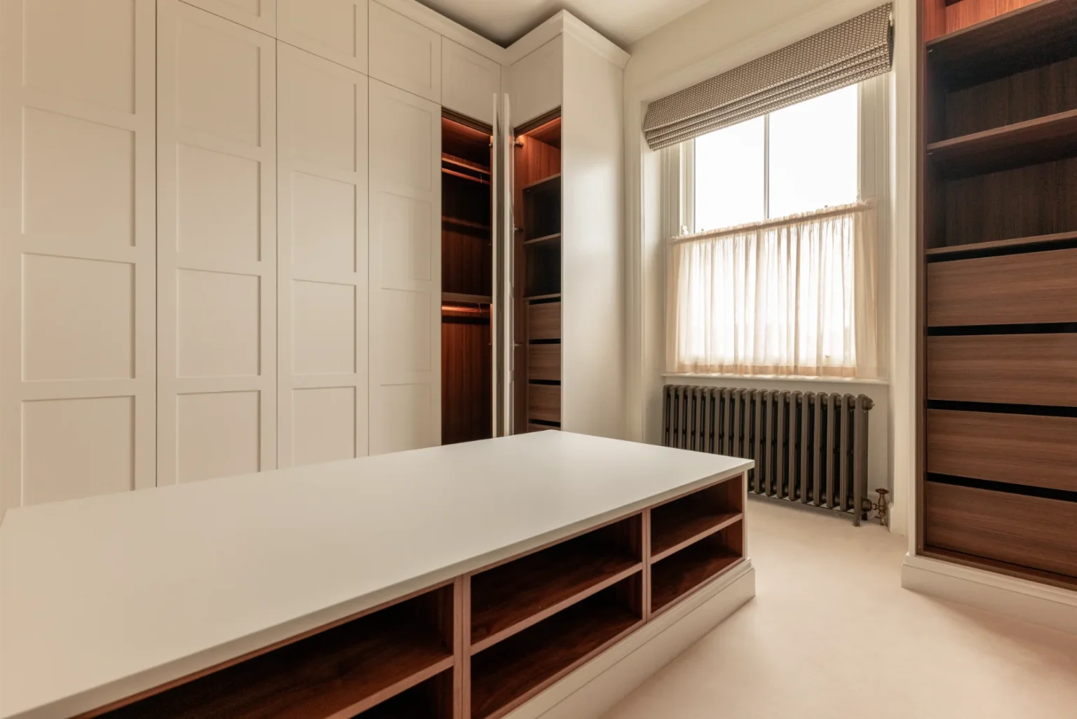 Spacious, modern walk-in closet with window light.