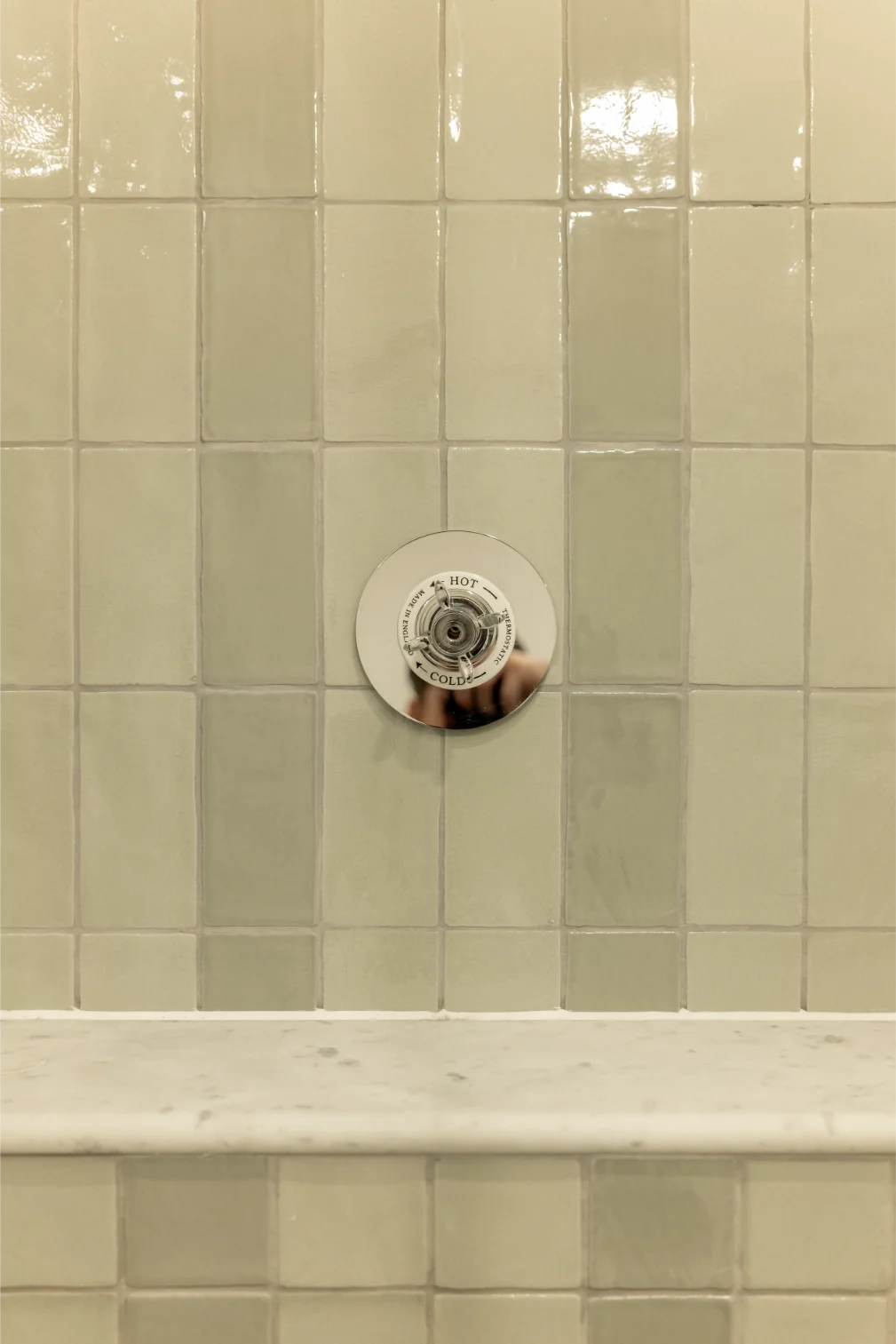 Bathroom shower wall with faucet control