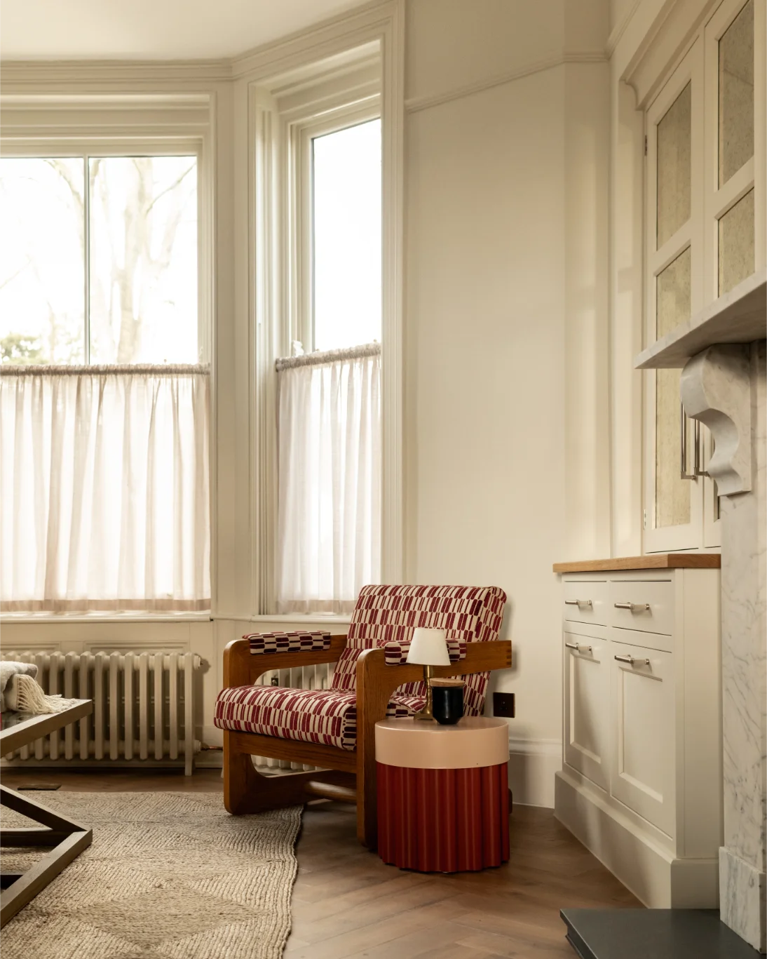 Cozy room with armchair and window light.