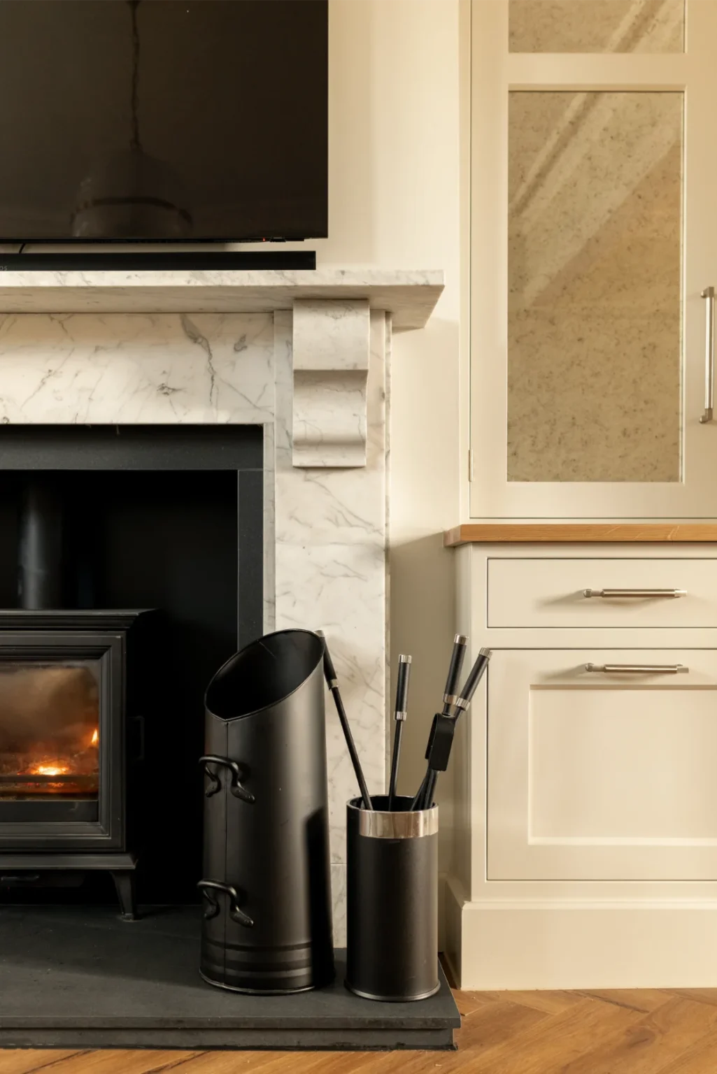 Modern fireplace with tools and marble mantel