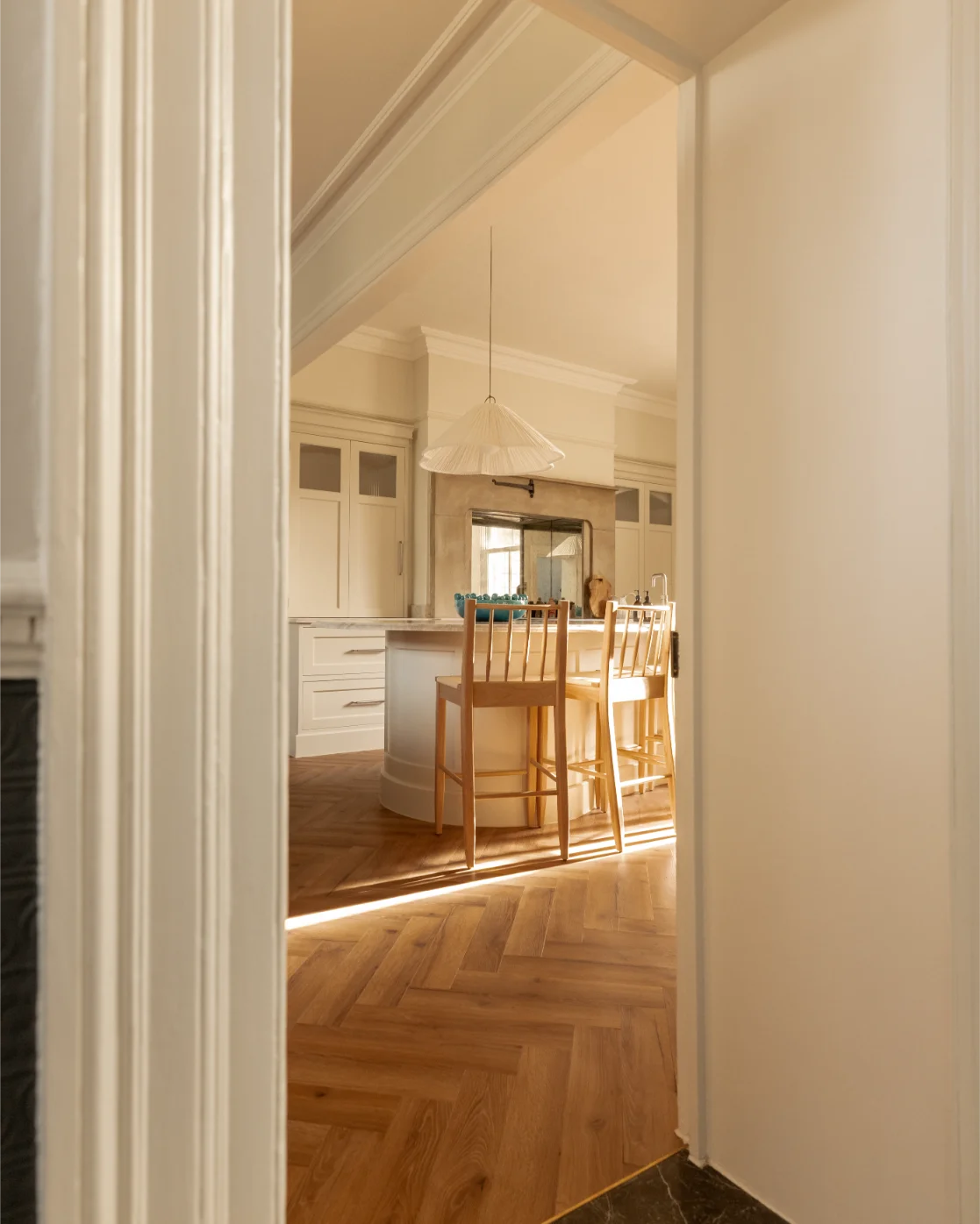 Cozy kitchen with wooden floor and island.
