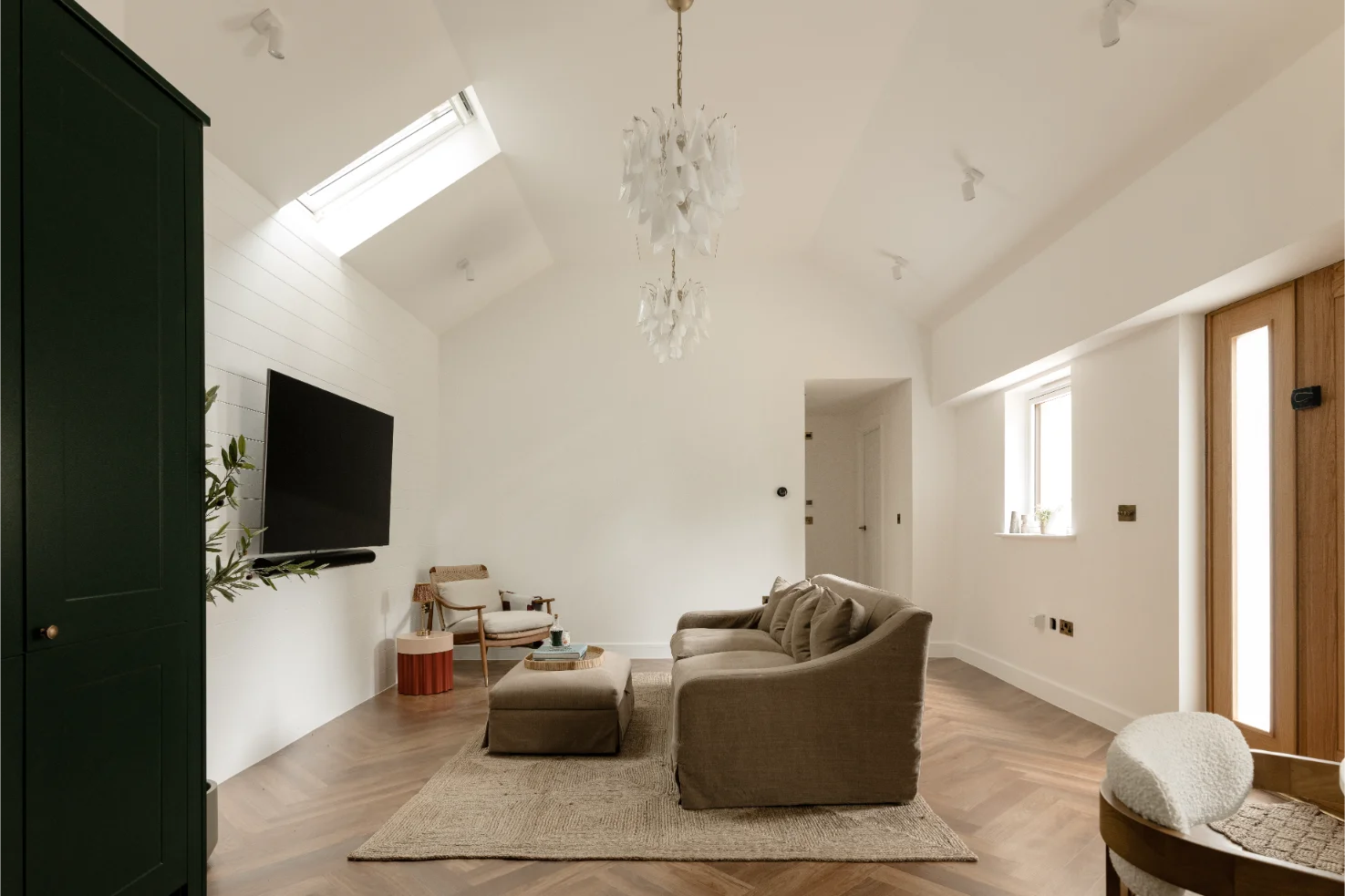 Cozy living room with modern decor and skylight.