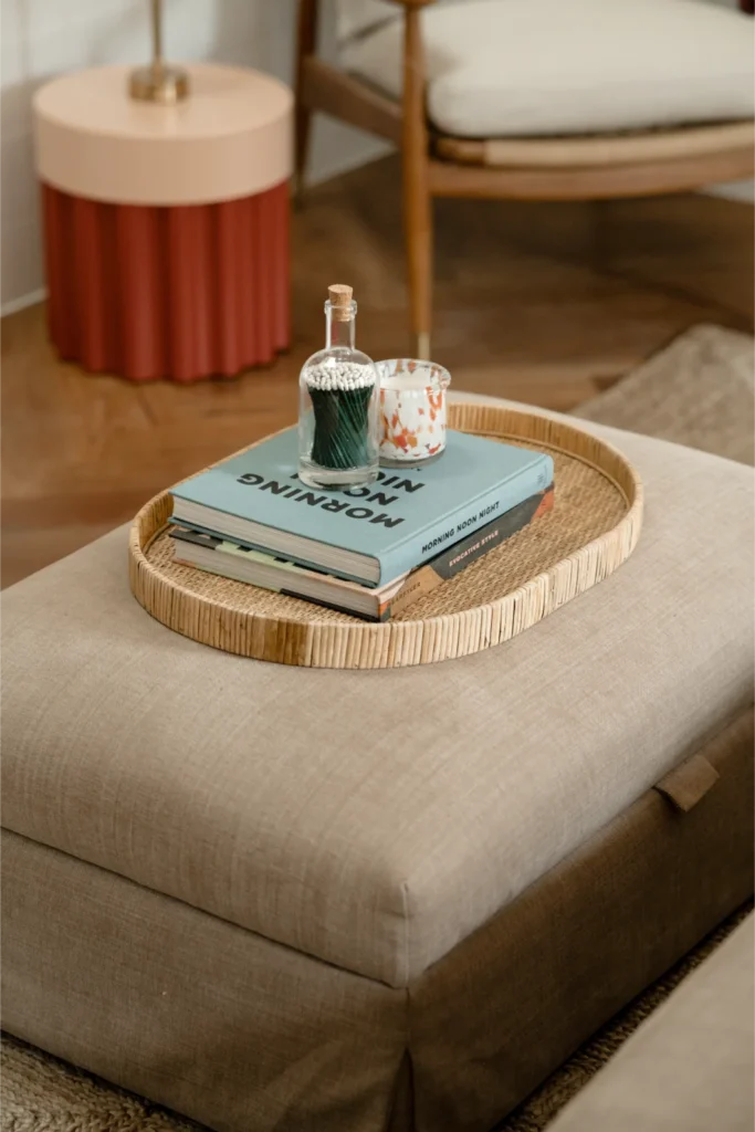 Ottoman with tray, books, candles, and matches.