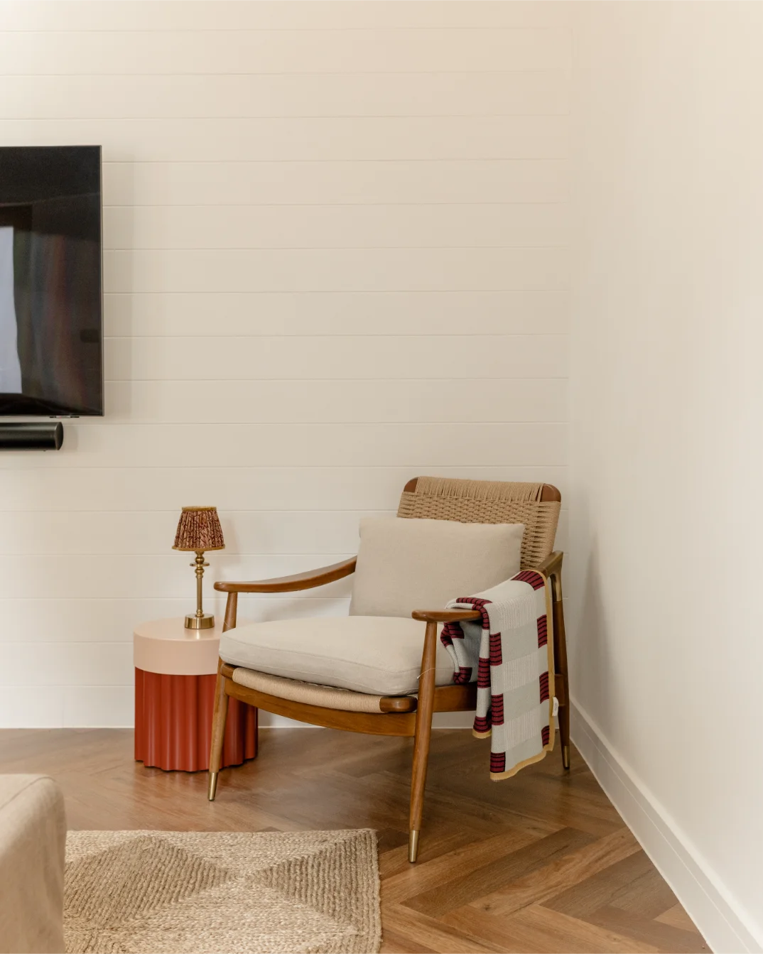 Cozy chair with blanket and small lamp