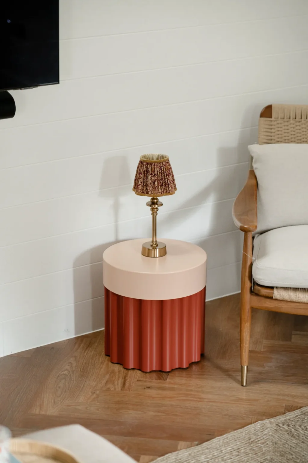 Stylish table with lamp and chair in living room.