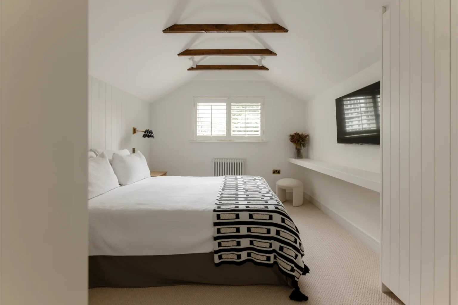 Modern minimalist bedroom with white decor.
