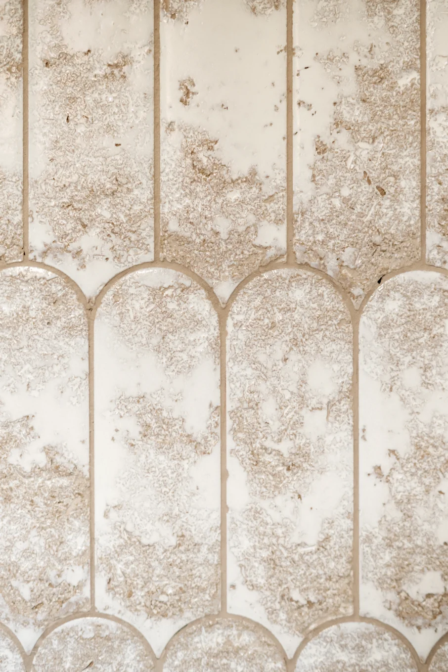 White and beige textured wall tiles arrangement.