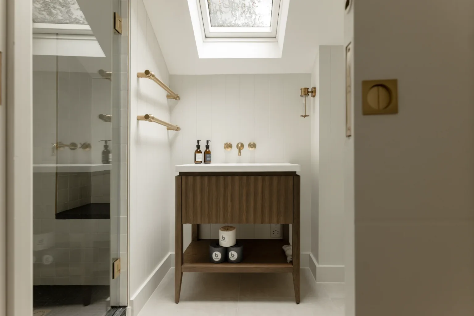 Modern bathroom with skylight and vanity sink.