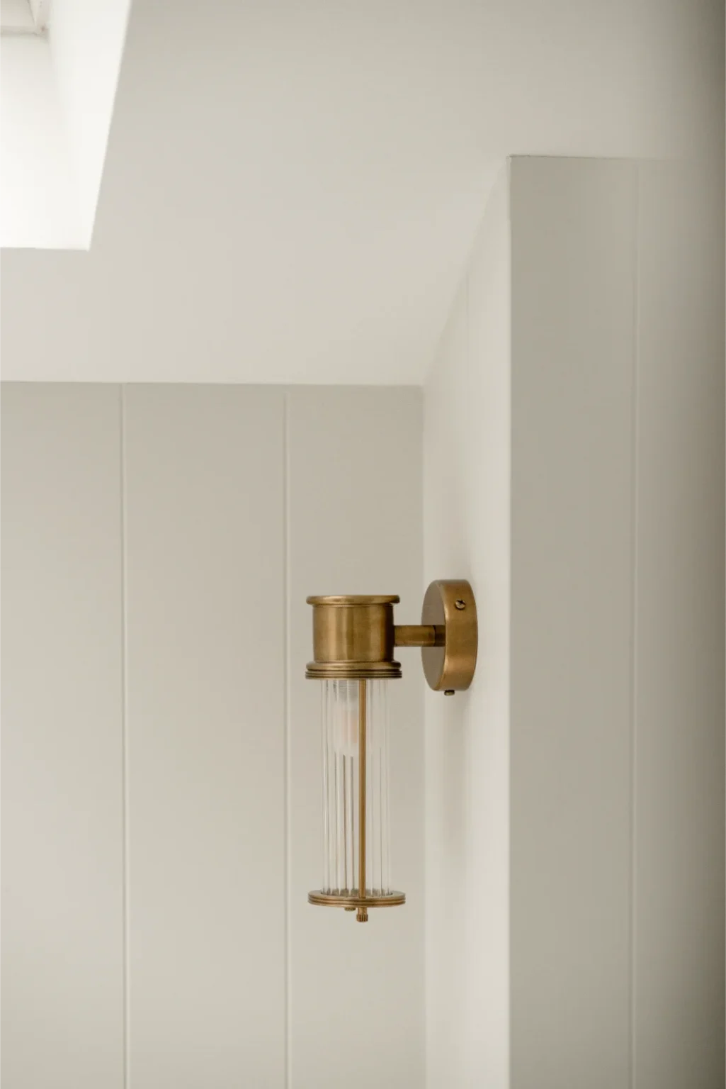 Vintage brass wall sconce on white wall