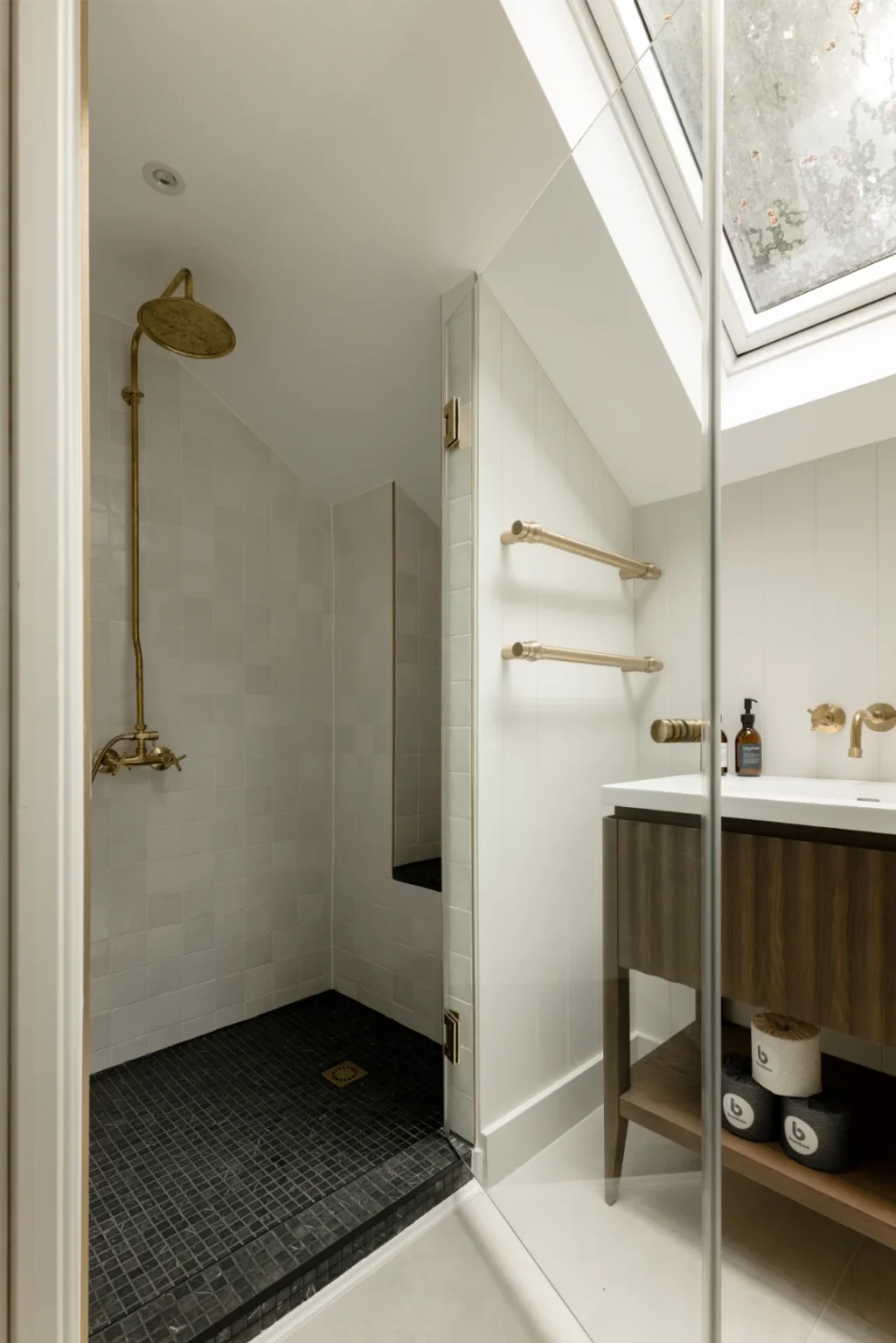 Modern bathroom with glass shower and skylight