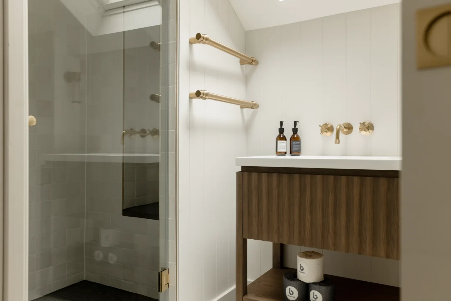 Modern bathroom with glass shower and wooden vanity