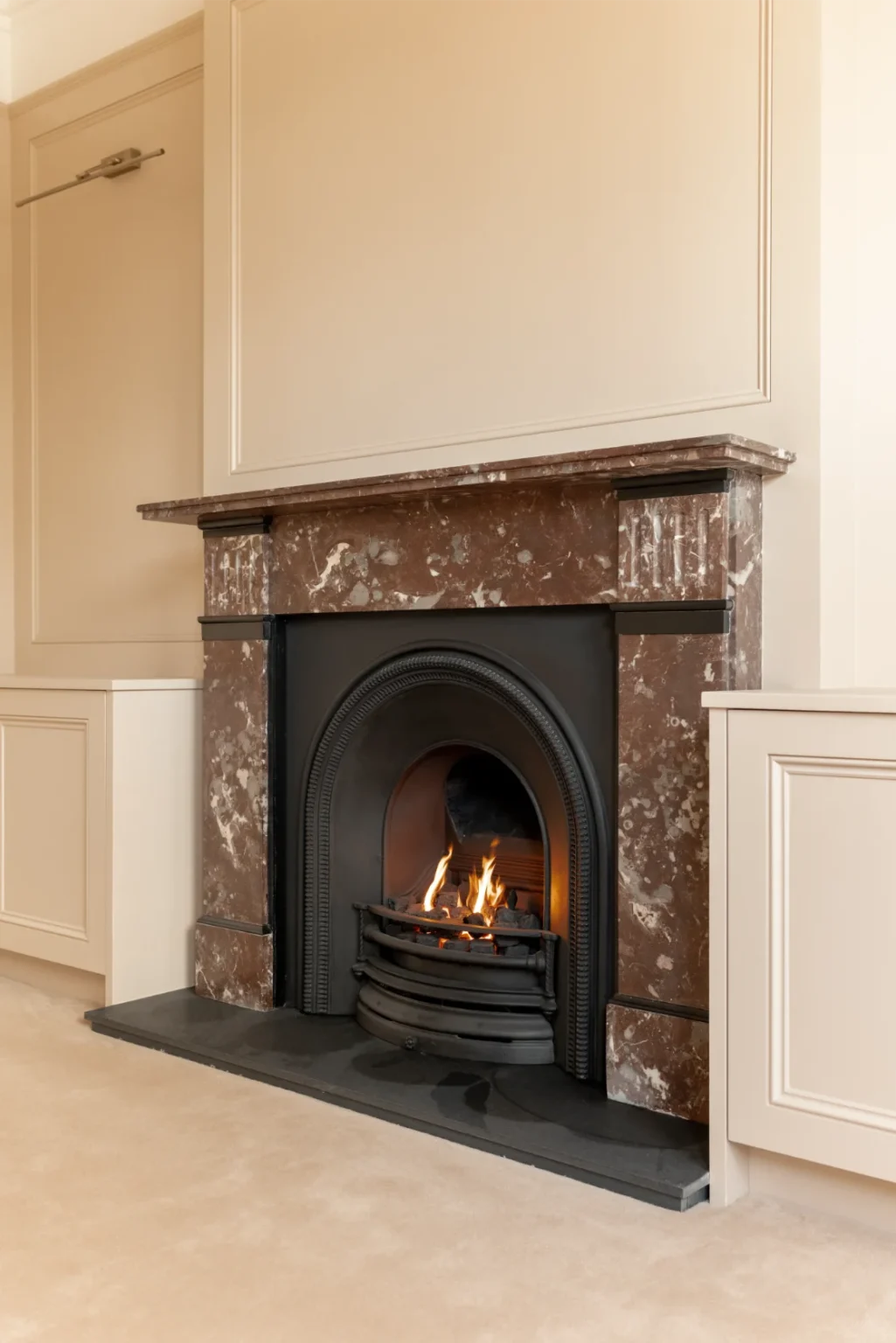 Traditional marble fireplace with burning fire