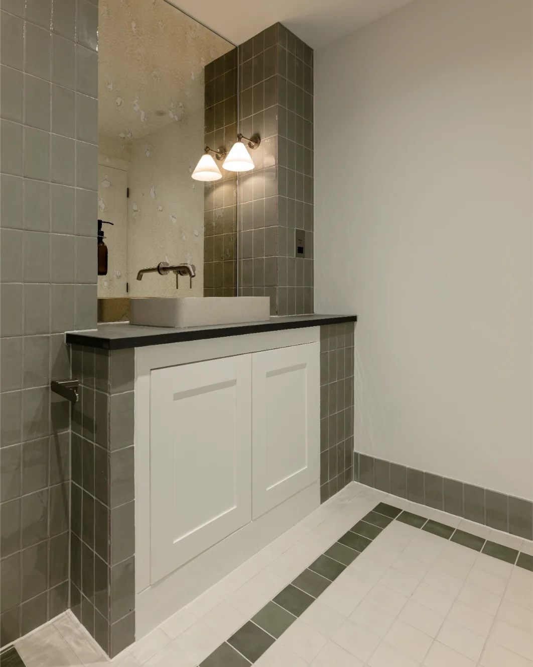 Modern bathroom with gray tiled sink area