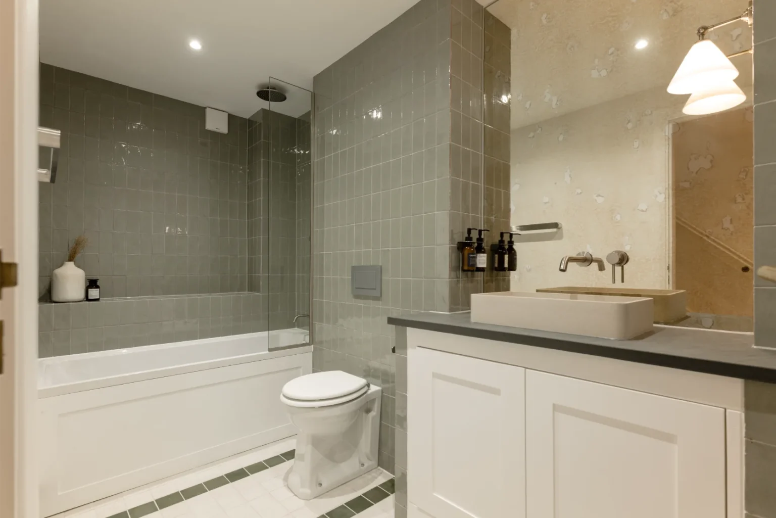 Modern bathroom with bath, sink, and toilet.