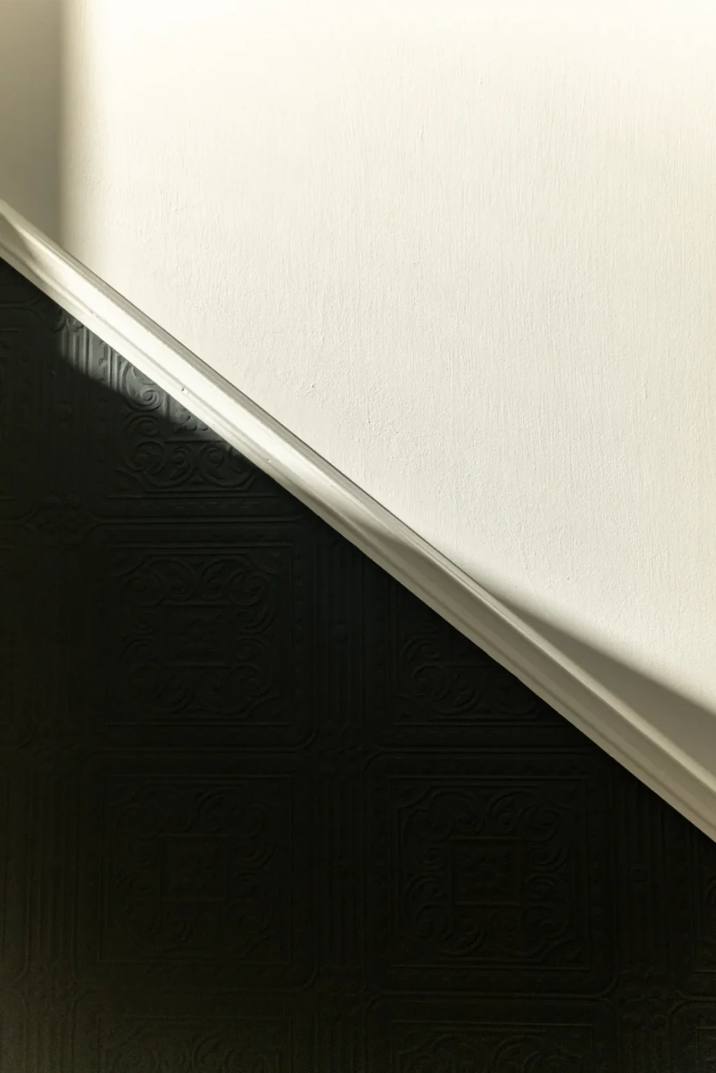 Diagonal light shadow on patterned wall