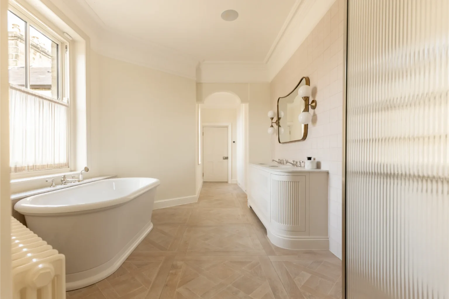 Elegant bathroom with bathtub and vanity mirror.