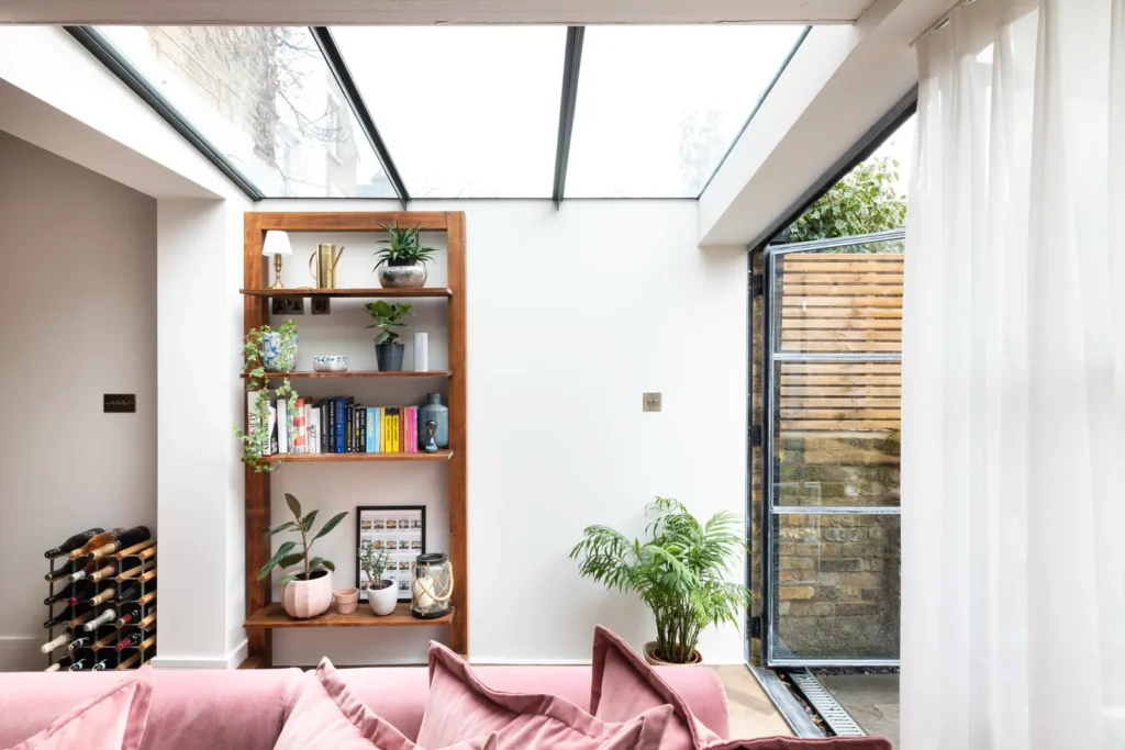Modern living room with skylight and bookshelves.